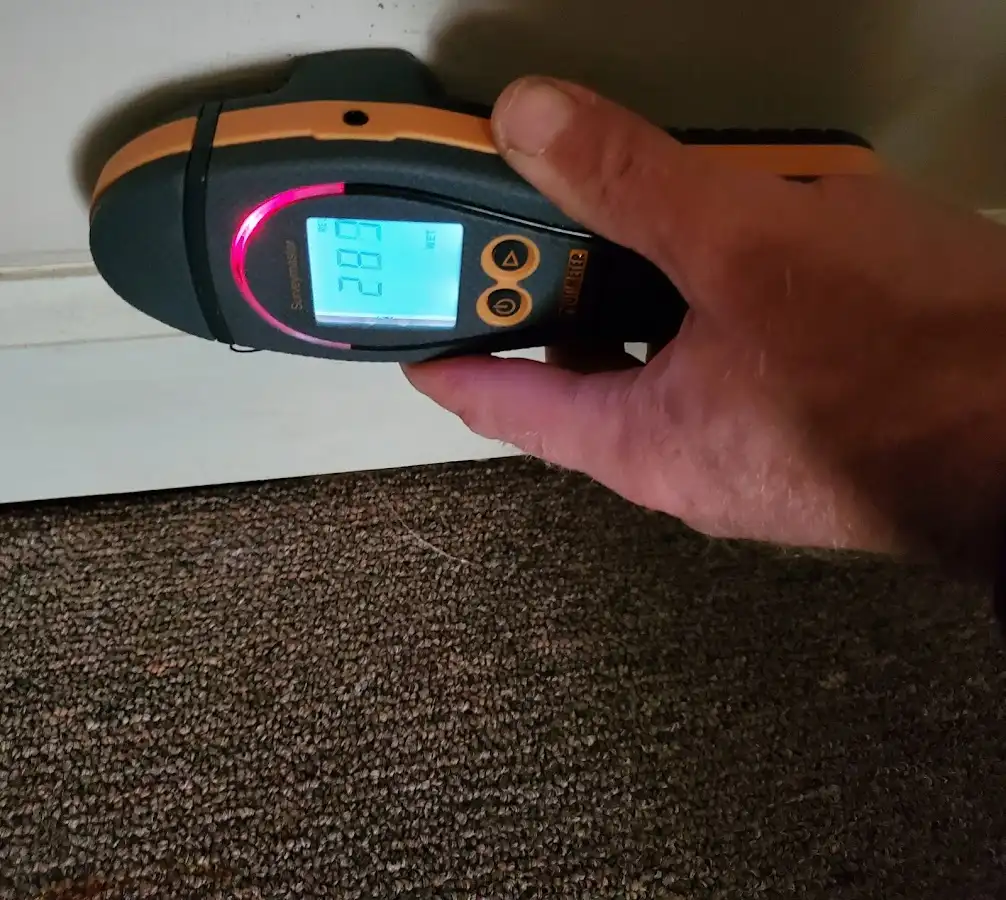 Moisture detection at baseboard during Storm Damage Restoration in Frankford